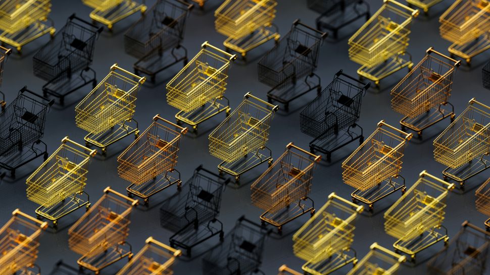 A group of shopping carts, some orange and yellow and some black